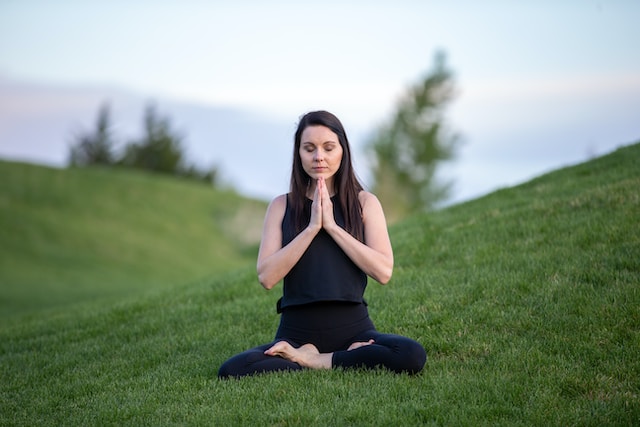 A woman in a meditative pose.