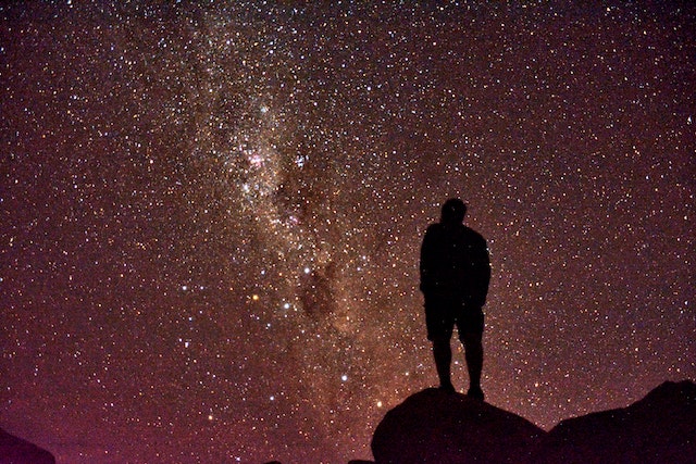 Silhouette of a person gazing up at the stars.