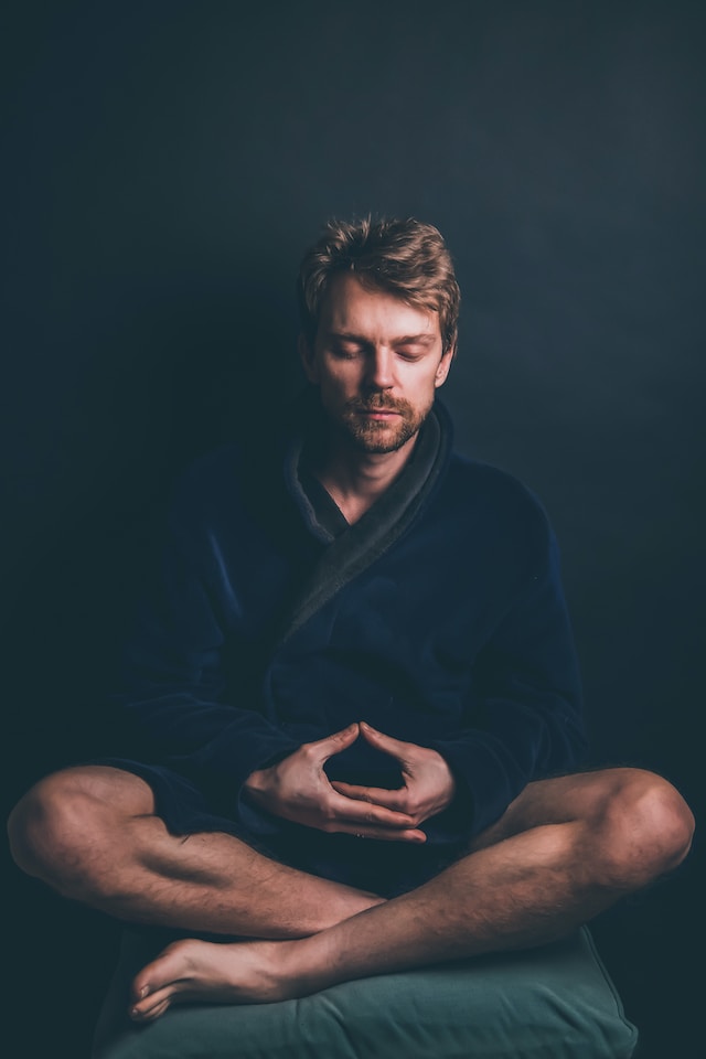A guy in dark robes meditating