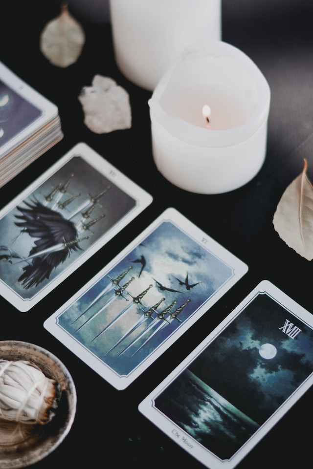 Tarot spread beside a lighted candle