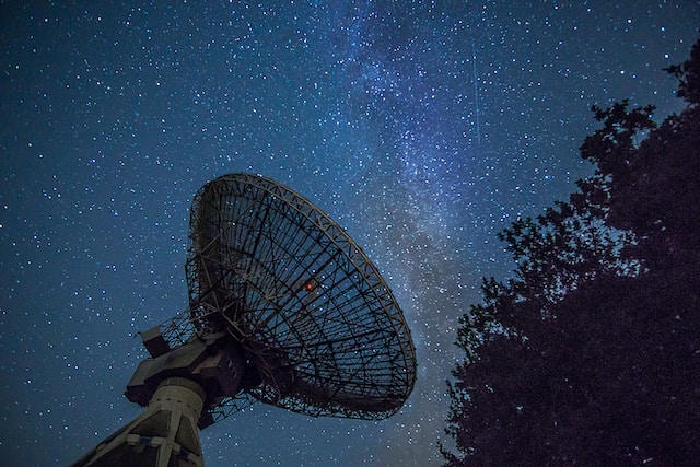 A radio telescope aiming up at the night sky