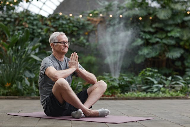 Mature man meditating outdoors